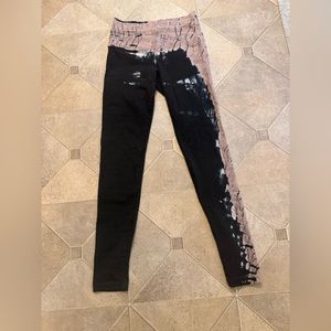 Hard Tail leggings, mostly black with a slight bit of tie dye color.